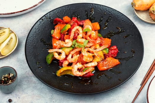 Fried crispy shrimp with fruit sauce. Salad with shrimps, prawns and caramel sauce.
