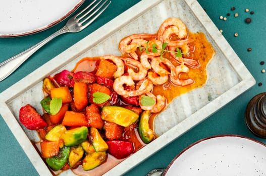 Fried crispy shrimp with fruit sauce. Salad with shrimps, prawns and caramel sauce.