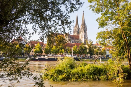 Regensburg in Germany, view to the old town framed by nature with Danube river in the foreground