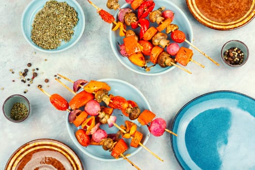 Skewers with tasty vegetables. Barbecue grilled vegetable kebabs on a plate.