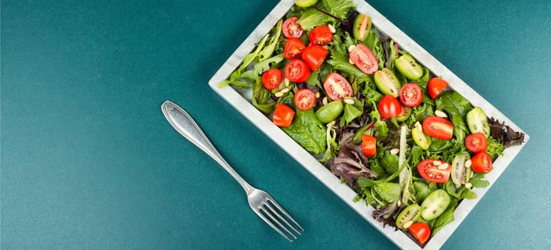 Tasty salad with tomatoes, different lettuce and pine nuts. Concept for a healthy food. Free space for your text.