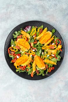 Cactus salad with sliced opuntia or prickly pear, peppers, almonds and fresh herbs, served in plate. Flat lay