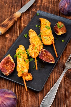 Shish kebab with chicken fillet and sweet figs. Grilled meat skewers. BBQ, chicken skewers.