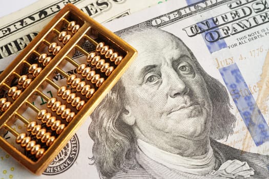 Gold abacus on banknote money, finance trading investment business currency concept.