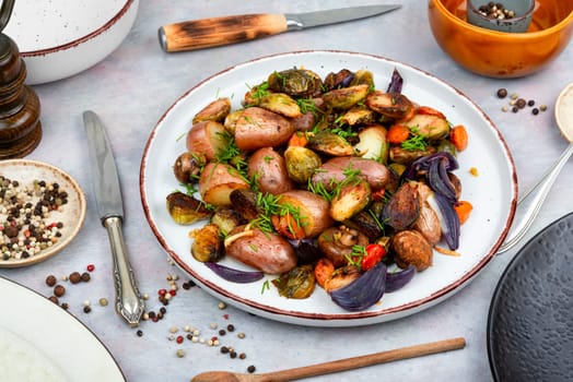 Roasted brussels sprouts and potatoes, food photography. Veggie dish, healthy eating, vegetable still life.