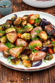 Roasted brussels sprouts and potatoes, food photography. Veggie dish, healthy eating, vegetable still life.