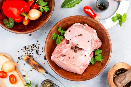 Sliced raw pork meat and fresh vegetables. Meat food. Top view.