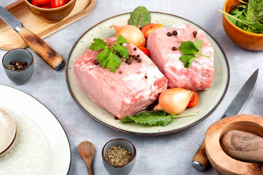 Sliced raw pork meat and fresh vegetables. Meat food. Top view.