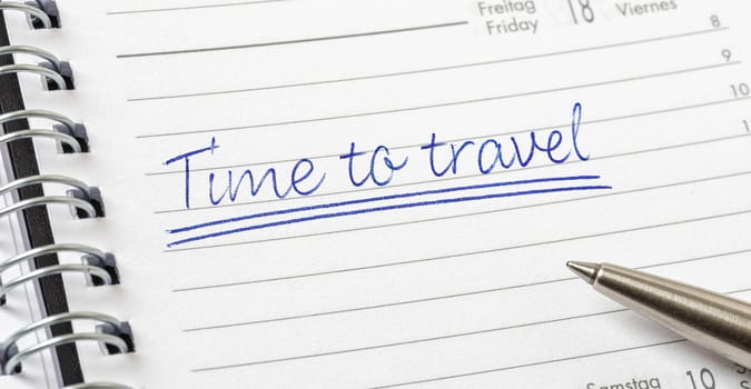 Time to travel written on a calendar page