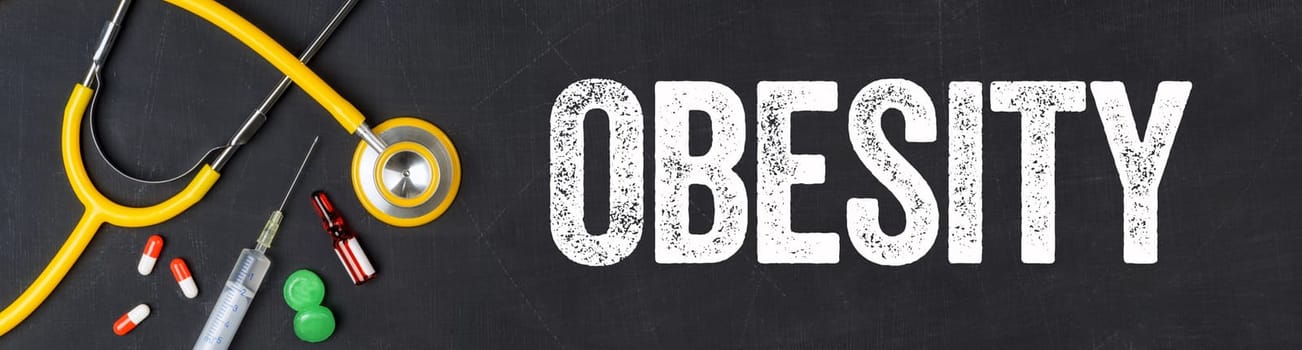 Stethoscope and pharmaceuticals on a blackboard - Obesity