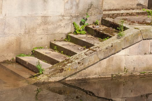 Old brown steps by a body of water, Germany