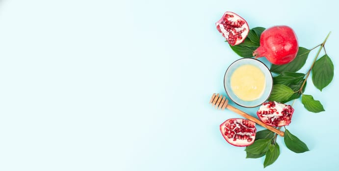 Rosh hashana, jewish new year holiday, background with pomegranate and honey, traditional food for celebration