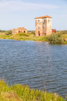 Italy, Comacchio lagoon with blue sky. Panorama with country and canals.