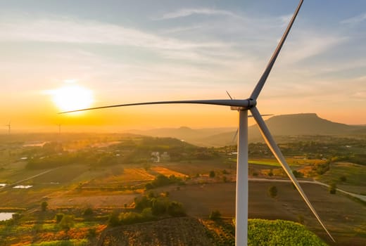 Wind farm field and sunset sky. Wind power. Sustainable, renewable energy. Wind turbines generate electricity. Sustainable development. Green technology for energy sustainability. Eco-friendly energy.