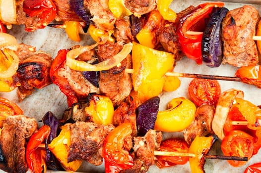 Meat kebabs with vegetables, shish kebab BBQ meat with onions. Top view with copy space.