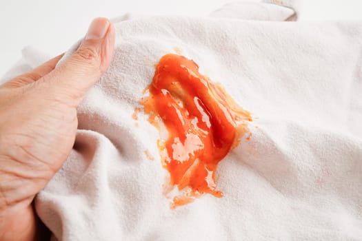 Dirty tomato sauce stain or ketchup on cloth to wash with washing powder, cleaning housework concept.