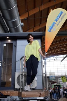 Model Cora is visibly having fun at the trade fair novelty,the brand new houseboat   The Interboot 2024 Friedrichshafen trade fair will open its doors on 25.09.2024