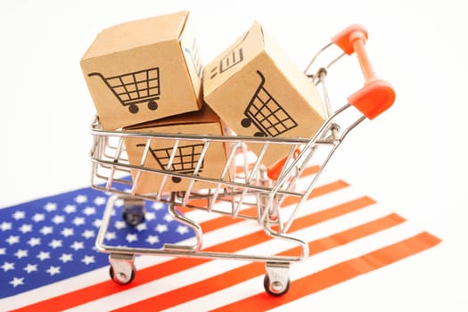 Online shopping, Shopping cart box on US America flag, import export, finance commerce.
