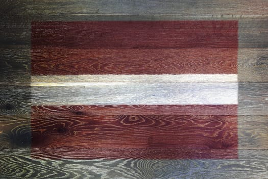 A Latvia flag on rustic old wood surface background