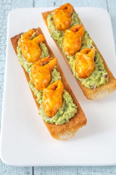 Toasts with avocado guacamole and crab claws
