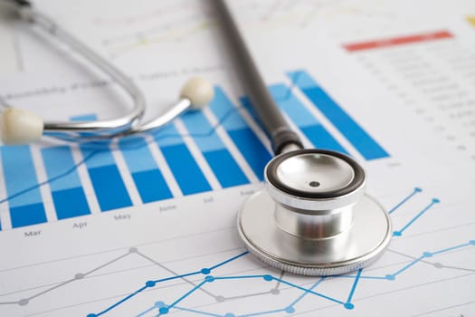 Stethoscope on chart or graph paper, Financial, account, statistics and business data medical health.