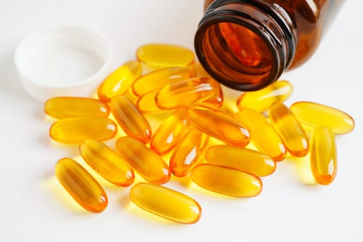 Fish oil or Cod liver oil gel in capsules with omega 3 vitamins, supplementary healthy food.