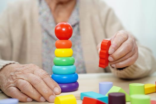 Asian elderly woman playing game.