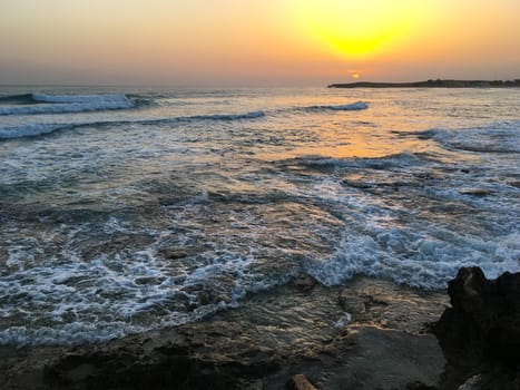 Sunset in Cyprus. View of coast at sunset. Promenade of the Mediterranean sea. Evening landscape of Cyprus