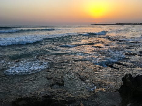Sunset in Cyprus. View of coast at sunset. Promenade of the Mediterranean sea. Evening landscape of Cyprus