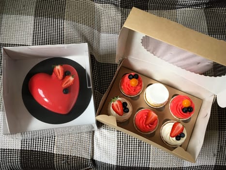 Set of Valentine's day desserts with heart-shaped cake and cupcakes.