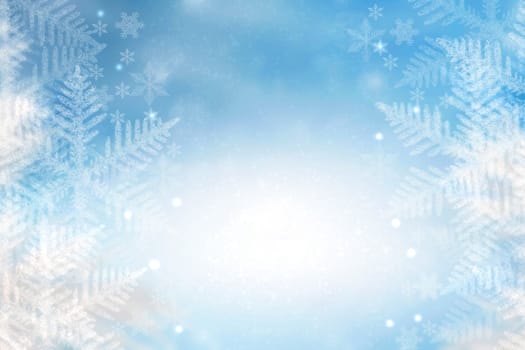 Abstract blurred festive winter christmas background texture with shiny blue and yellow white bokeh lighted snow landscape with stars and blue sky.