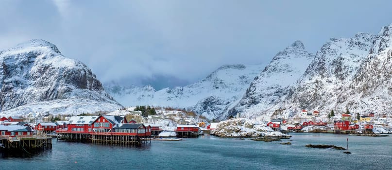 Panorama of traditional fishing village A on Lofoten Islands, Norway with red rorbu houses. With snow in winter