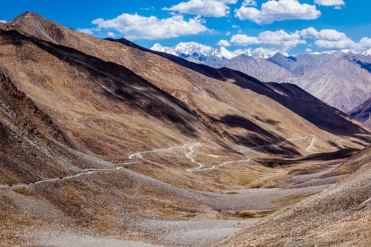 Himalayan valley landscape with road near Kunzum La pass - allegedly the highest motorable pass in the world (5602 m), Ladakh, India