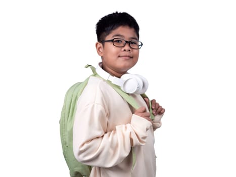 Portrait of boy in casual clothes carry a green bag and white headphones isolated on a white background, The concept of education and way of life. Cute boy posing in casual clothes with clipping part.