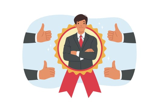 Man became best employee of month, looking out from medal located among fingers up. Guy best employee of month, stands with arms crossed and feels confident or ready for professional challenges.