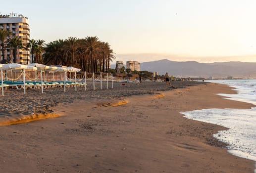 Torremolinos, Spain - September 12, 2023: View of Bajondillo Beach in Torremolinos at sunrise. Costa del Sol, Spain.