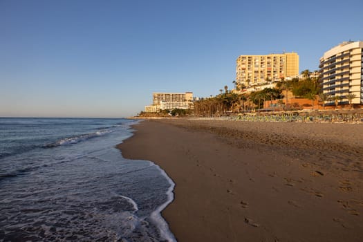Torremolinos, Spain - September 12, 2023: View of Bajondillo Beach and hotels in Torremolinos at sunrise. Costa del Sol, Spain.
