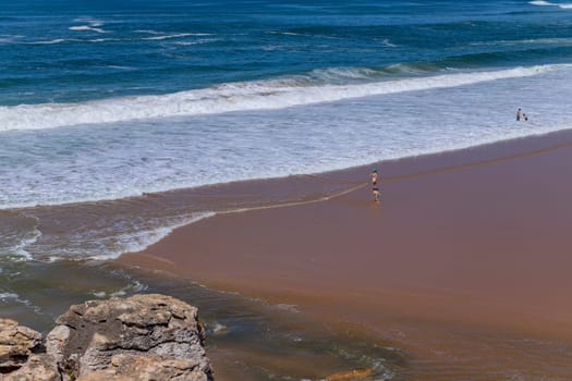 Sintra, Portugal: April 13, 2024: People at the beach of Foz do Lizandro, Ericeira, Portugal