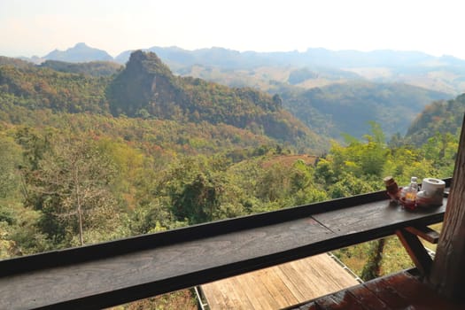 View from a restaurant terrace onto the hilly landscape of northern Thailand, overgrown by a dense, lush, forest, jungle, on the Mae Hong Son Loop, close to Pai, Thailand 2023