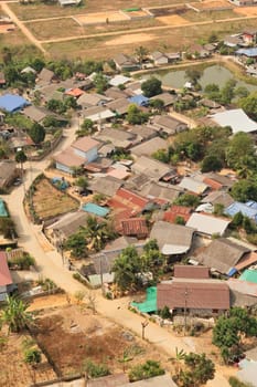 Picturesque view from the Guan Yin Statue onto a neighborhood of a traditional, rural village right next to it, Wat Huay Pla Kang Temple Complex, Chiang Rai, Thailand 2023