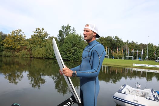 Kitsurfer Ben Beholz gives taster courses on the Messesee and does show acts in pump and wingfoiling  The 63rd Interboot 2024 trade fair in Friedrichshafen has opened