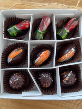 Box of artisanal chocolates vibrant, artistic designs for chocolate enthusiasts. Luxury of gourmet confections. Artistic expression in food and gourmet experience concept.