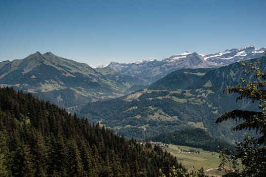 Scenic panoramic view on the Rhone valley near Aigle with the Diablerets and the Pic Chaussy in the background. Bright day in summer. Leysin, Vaud, Switzerland