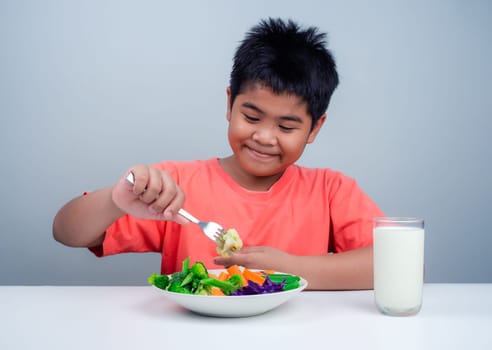 Children like to eat vegetables, Little cute boy eat healthy vegetables, Nutrition healthy eating habits for kids concept, Mixed color vegetables.
