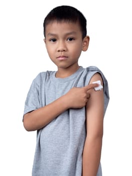 Little asian child boy wearing short-sleeve shirt with bandage plaster on her arm after vaccination for boost immunity. Injection covid vaccine, Tetanus vaccine, Flu vaccine, healthcare for children.