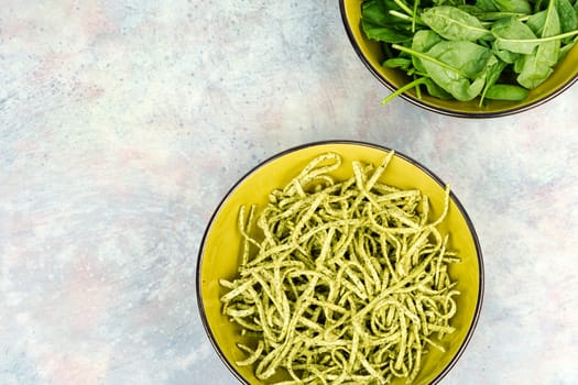 Italian cuisine vegan food Conchiglie pasta topped with spinach. Copy space.