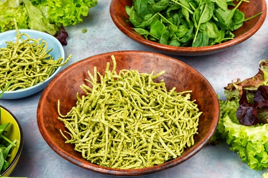 Italian cuisine vegan food Conchiglie pasta topped with spinach. Copy space.