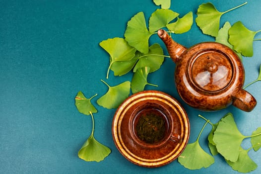 Medicinal plant ginkgo biloba, mortar and pestle on a wooden table, Ginkgo biloba herbal medicine.