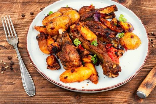 Spare ribs or grilled ribs with stewed vegetables. Barbecue ribs.