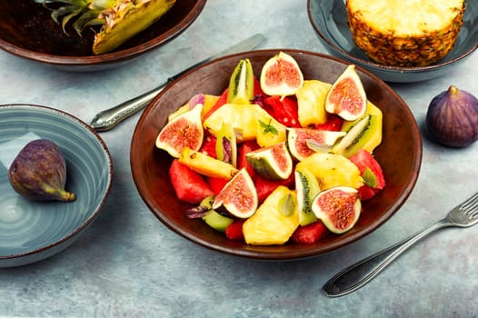 Fruit salad with pineapple, watermelon, kiwi and figs.